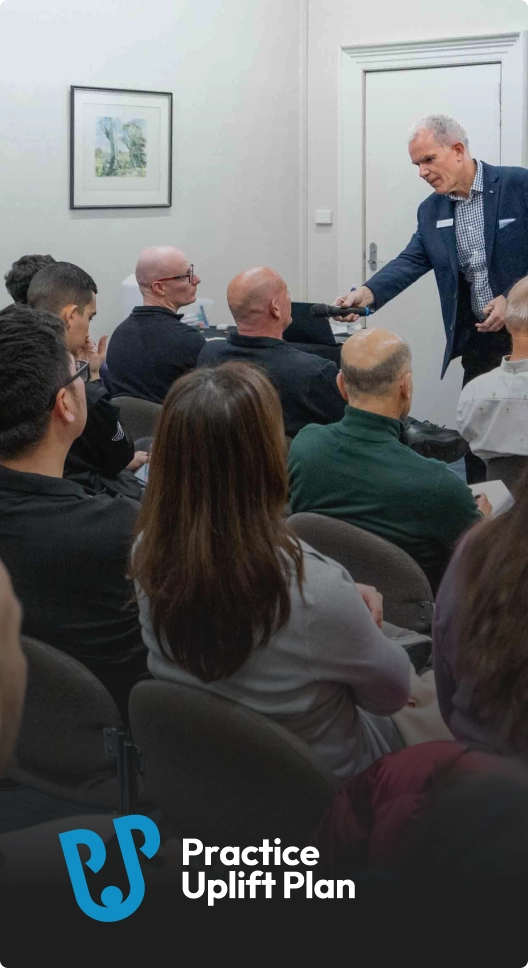 Angus Pryor speaking to an audience in a conference setting.